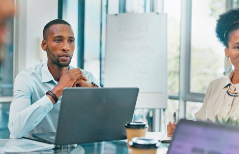 web5 Corporate, black man and team in meeting, brainstorming and feedback for new project, discussion an.